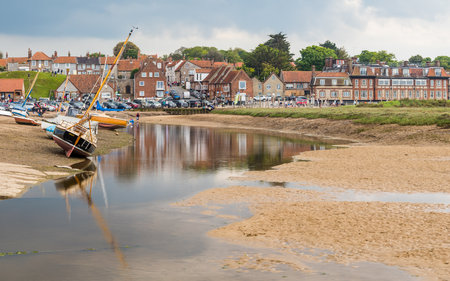 Multi image panorama of boats beached by the low tide leading to Blakeney Quay on the North Norfolk coast.のeditorial素材