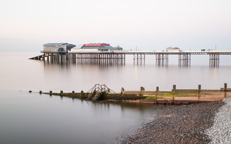 Long exposure of Cromer pier to blur the waves around its stilts as it juts out into the North Norfolk coast, pictured in June 2021.のeditorial素材