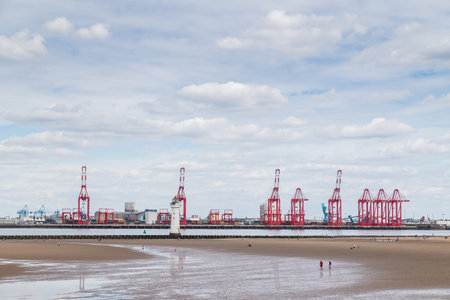 Wallasey beach in front of the Liverpool docks seen on the other side of the River Mersey seen in England in July 2020.のeditorial素材