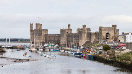 Caernarfon waterfront and castle which make up the Unesco Heritage site seen on the North Wales coast in October 2021.のeditorial素材