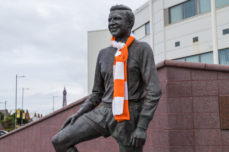 A statue of former Blackpool FC player and manager Jimmy Armfield seen outside Bloomfield Road stadium in September 2021 with the Blackpool Tower in the background.のeditorial素材