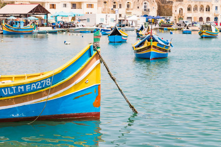 Luzzu boats in Marsaxlokk harbour pictured in April 2022 during a visit to Malta.のeditorial素材