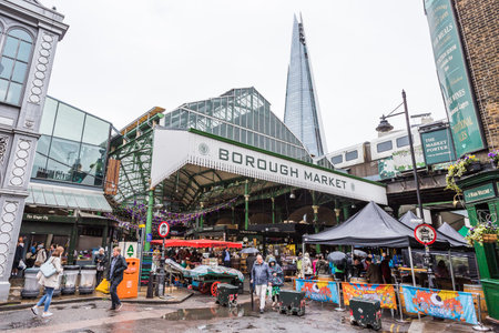 The indoor Borough Market pictured under the towering Shard Building in London after rainfall in May 2022.のeditorial素材