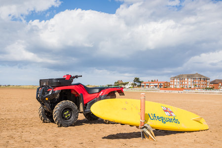 RNLI paddle board and quad bike seen on the beach at West Kirby on the Wirral penninsula seen in August 2022.のeditorial素材