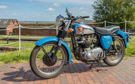 Blue BSA motorcycle parked on paving in Cheshire pictured in August 2022.のeditorial素材