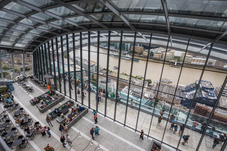 Looking down on tourists on the outside roof terrace of the Sky Garden on top of the Walkie Talkie Building in London seen in August 2022.のeditorial素材