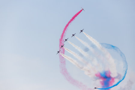 Synchro pair of the Red Arrows roll around Enid formation at Blackpool, Lancashire in August 2022.のeditorial素材