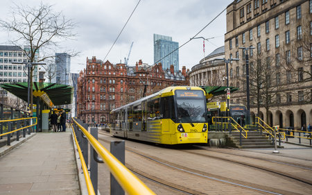 Two trams waiting at a stop in St Peters Square, Manchester seen in February 2023.のeditorial素材