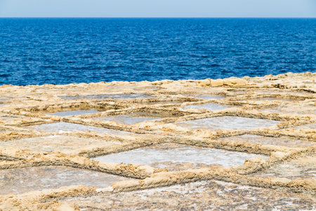 Xwejni salt pans next to the sea pictured on the island of Gozo, Malta.の写真素材
