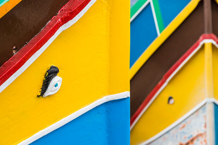 A pair of Luzzu boats fill the frame with colour at Mgarr harbour on the island of Gozo (Malta) seen in April 2022.の写真素材