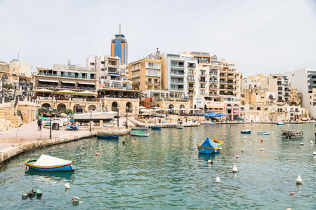 Spinola Bay in Sliema seen in April 2022 full of boats and surrounded by buildings in Malta.の写真素材