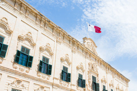 Malta flag above Castile Place seen in April 2022 during a trip to Valletta, the capital city of Malta.の写真素材
