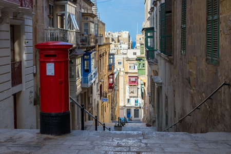 An old red post box seen above a steep street in Valletta, Malta in April 2022.の写真素材