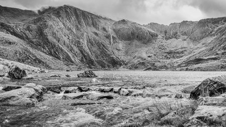 Rain water falls down the Glyderau mountain causing the water in Lake Idwal to flow towards Ogwen in the Snowdonia National Park in October 2021.の写真素材
