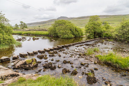 Stepping Stones over River Doe seen above Beezley Falls on the Ingelton Waterfalls Trail in North Yorkshire.の写真素材