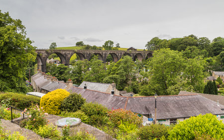 The disused Ingleton Viaduct seen crossing the valley where the pretty village is situated in the Yorkshire Dales seen in June 2022.の写真素材