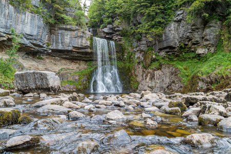 Thornton Force captured from a low point of view over the fallen rocks on the Ingelton Waterfalls Trail in North Yorkshire.の写真素材