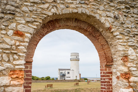 The ruins of St Edmunds Chapel frames the lighthouse at Hunstanton on the West Norfolk coast pictured in July 2022.の写真素材