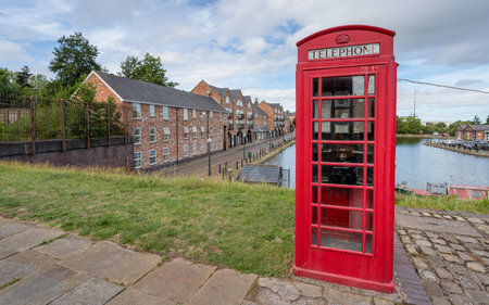 Old red telephone box seen in front of Ellesmere Port canal basin in Cheshire in August 2022.の写真素材