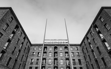 A tall sign marking the entrance to the Royal Albert Dock pictured in black and white in Liverpool in September 2022.の写真素材