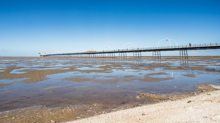 Pools of water in front of Southport Pier seen at low tide in October 2022.の写真素材