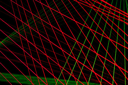 An abstract image of rows of brightly coloured string in rows against a dark background.