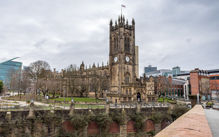 Manchester Cathedral seen from Cathedral Approach over the Irwell River in February 2023.の写真素材