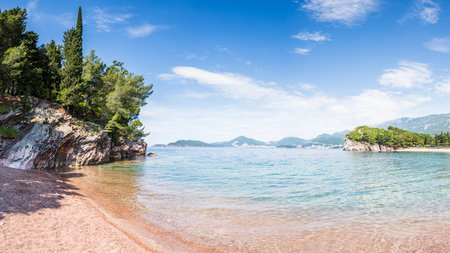 A multi image panorama of the shallow shoreline of Milocer Beach on the Montenegro coastline.の写真素材