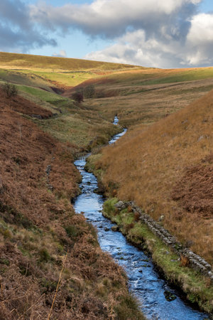 River Dane flowing down a valley towards Three Shires Head in the Peak District.の写真素材