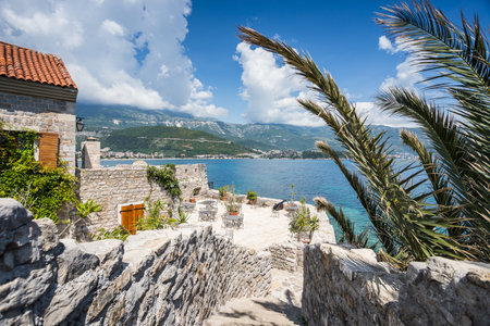 Steps lead to a corner of the Budva old town surrounded by its old city walls seen in May 2023 whilst in Montenegro.の写真素材
