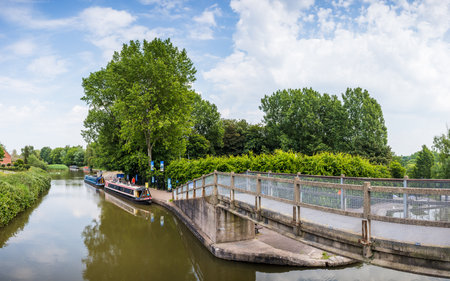 A multi image panorama captured from a footbridge at Anderton overlooking narrow boats on the Trent and Mersey canal in June 2023.の写真素材