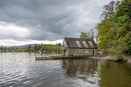 A traditional built boat house reflecting on Lake Windermere at Rayrigg Meadow in Cumbria seen on 6 May 2024.の写真素材