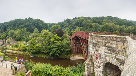 A multi image panorama of people seen admiring the Iron Bridge spanning the River Seven in the Ironbridge, Shropshire on 7 September 2024.の写真素材