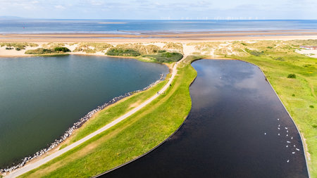 Overlooking the two lakes and path facing out to Crosby beach and the Irish Sea near Liverpool.の写真素材
