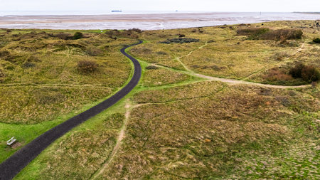 An aerial panorama of the Crosby Coastal Path veering  through the meadows and dunes between Crosby and Hightown.の写真素材