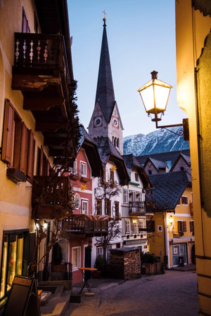 Narrow street with colorful old buildings in famous village Hallstatt during evening time. Cityspace and architecture.の写真素材