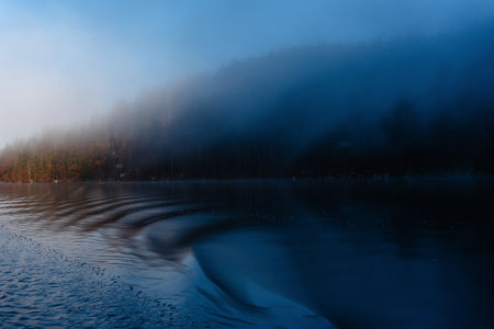 Long exposure shot in the evening. Beautiful morning during autumn in lake. Sunrise and fog