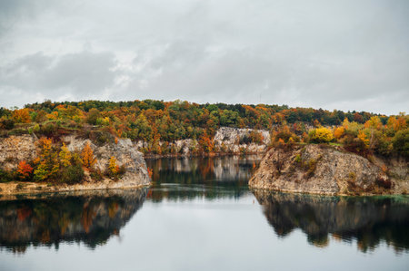 Autumn landscape with a lake in the middle of the forest.の写真素材