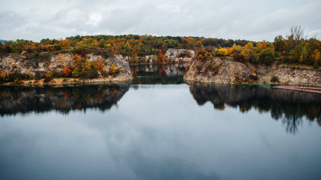 Autumn landscape with lake in the mountains. Colorful autumn trees on the shore.の写真素材