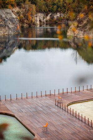 Wooden terrace on the bank of a mountain lake in autumn