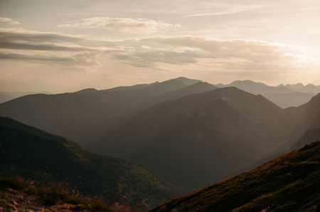Scenic view of mountain range at sunset with soft light and clouds. Tatry, Polandの写真素材
