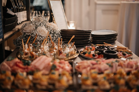 Elegant buffet table with appetizers and floral arrangement.