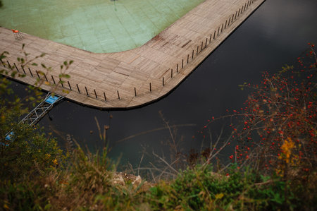 Aerial view of a wooden dock extending into a calm, dark water body. Zakrzowek, Krakowの写真素材