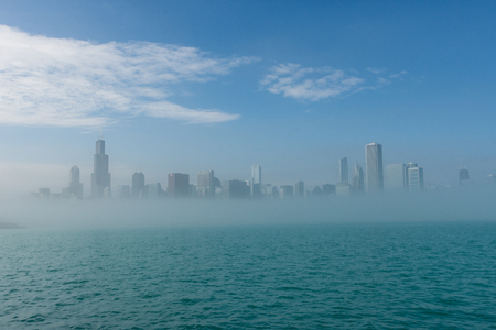 Chicago skyline panorama with skyscrapers over Lake Michigan with cloudy blue sky.の写真素材