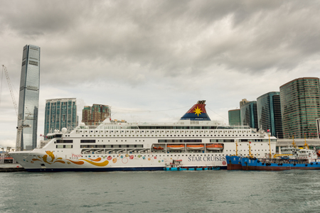 HONG KONG - JANUARY 11: Victoria Harbor on January 21, 2016 in Hong Kong. Big Cruise Ship on Terminal near Victoria Harbor.のeditorial素材