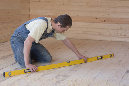 Carpenter checks the accuracy of the sub-floor horizon 