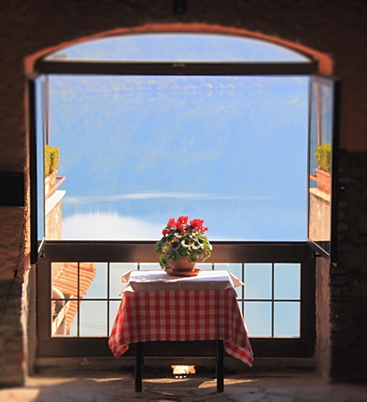 A table at a window with view over the seaの写真素材
