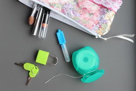 from home .toothbrush,floss,tablets lock and key,toiletries bagの写真素材