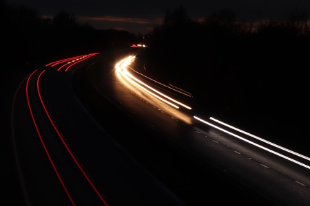 trails of lights from cars traveling along the highway motorway