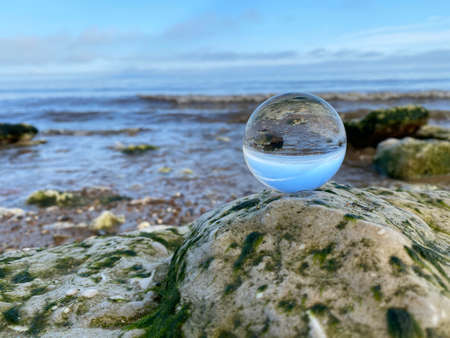 Glass ball photo of beach reflections in the glasses upside down